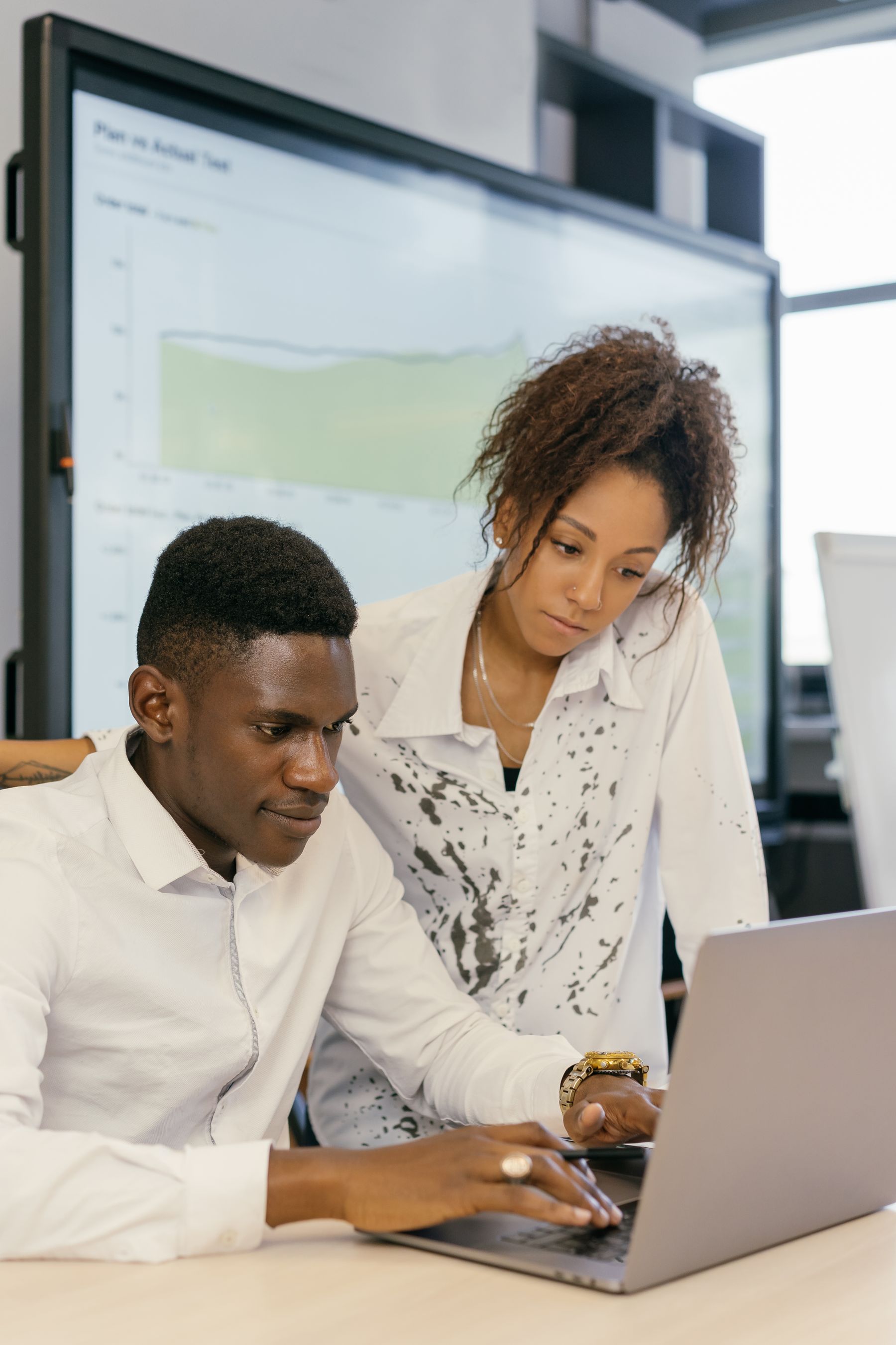 Software delivery colleagues reviewing product information on a laptop
