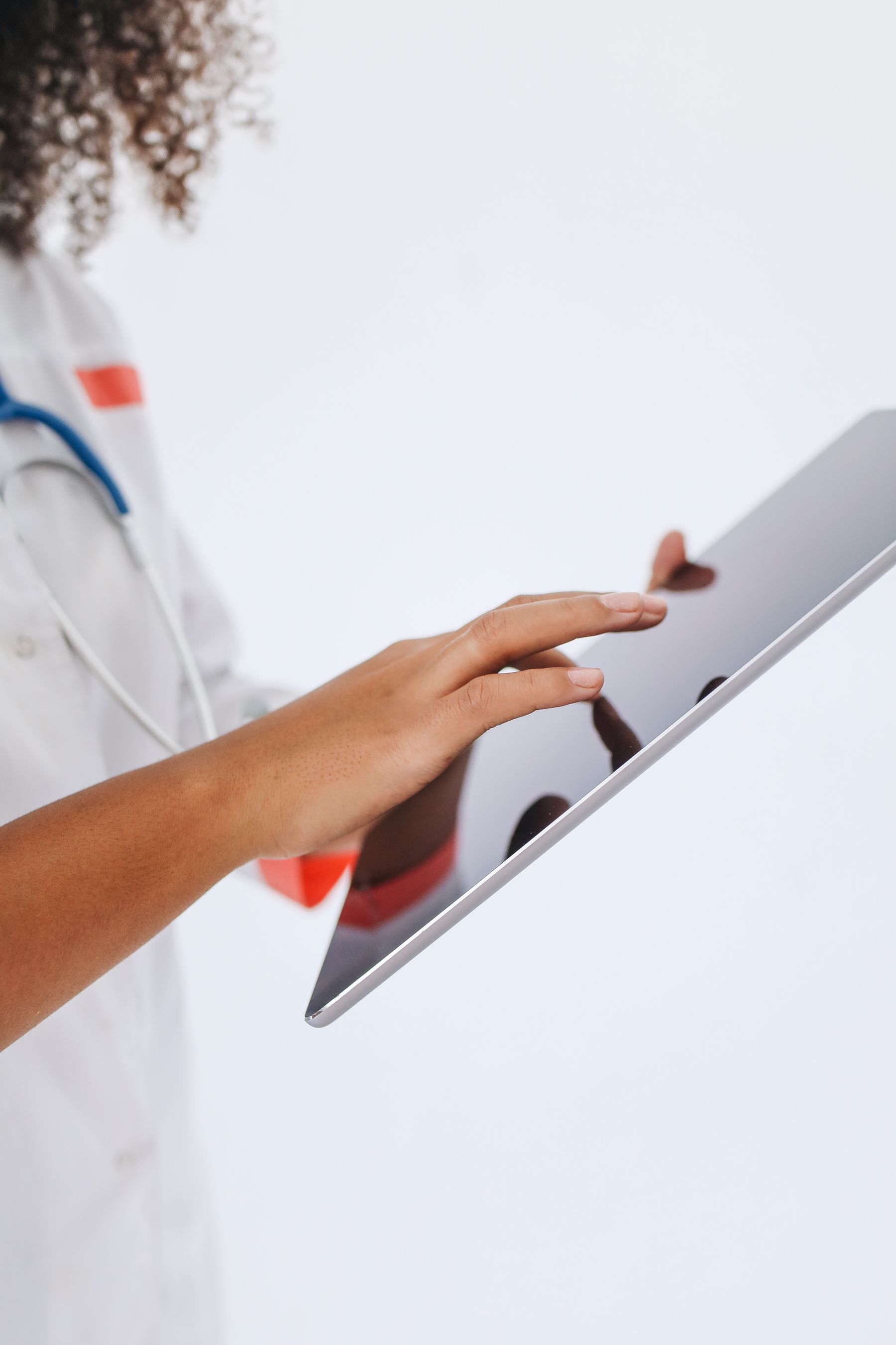 Healthcare professional using a tablet for digital care records