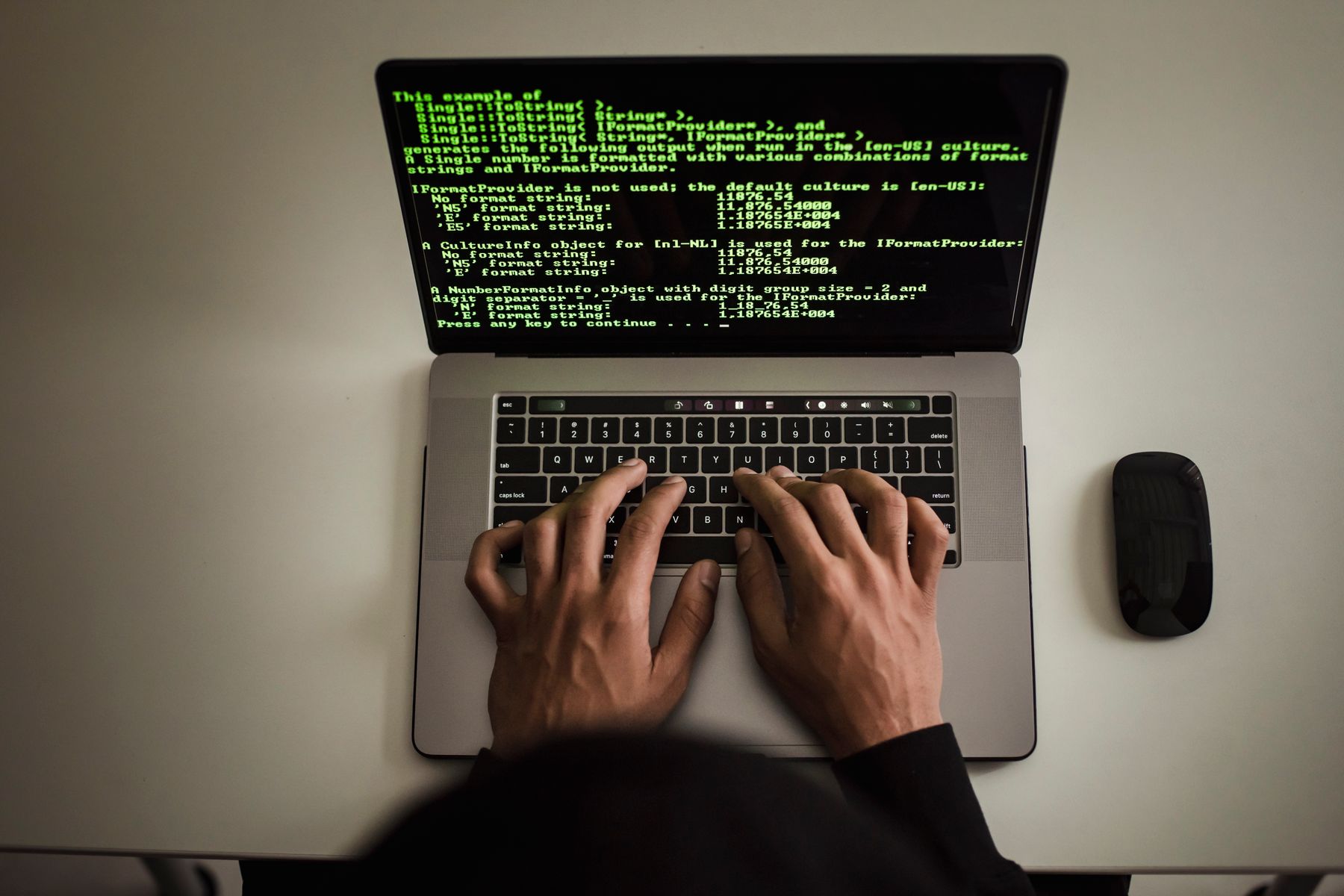 Software developer working with an established codebase on a laptop