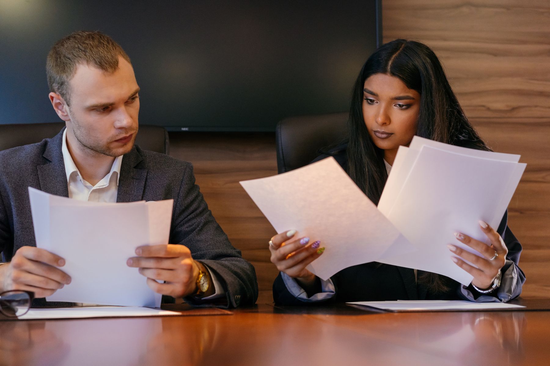 Colleagues reviewing business documents together in a professional office